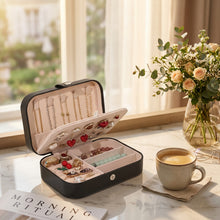 Load image into Gallery viewer, Leather portable travel jewelry box with multiple compartments for earrings, necklaces, and rings, neatly organized.

