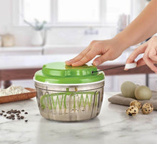 Load image into Gallery viewer, Person using a green kitchen tool on a marble countertop with a blurred kitchen background
