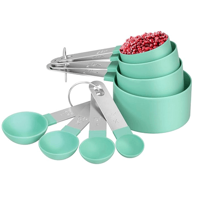 A set of measuring cups and spoons in various sizes made of stainless steel and BPA-free green plastic, displayed with a stackable design.