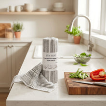 Load image into Gallery viewer, A roll of Yun Yang hand-torn rag with a white paper label, featuring a black and white striped pattern, on a plain white background.
