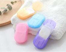 تحميل الصورة في عارض المعرض، Colorful fabric softener sheets in plastic cases on a white towel with a wooden board in the background.
