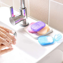 تحميل الصورة في عارض المعرض، Colorful soap containers on a sink with hands washing in the background
