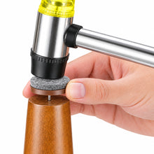 Load image into Gallery viewer, A close-up of a hand using a small hammer to remove a round gray felt pad from a metal pin attached to a wooden stand, on a white background.
