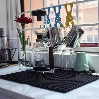Coffee-making setup on a kitchen counter with a window in the background