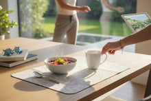 Load image into Gallery viewer, A rectangular mouse pad with rounded corners featuring a light gray and white leaf pattern, resting on a wooden desk.
