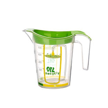Load image into Gallery viewer, A clear plastic oil measure with a bright green lid and handle, featuring yellow measurement markings and the text 'OIL RECYCly' on the front, set against a plain white background.
