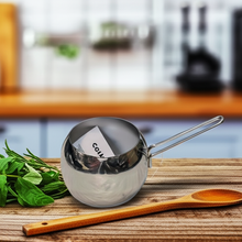 تحميل الصورة في عارض المعرض، Metal measuring scoop on a wooden cutting board with fresh herbs and a wooden spoon in a kitchen setting
