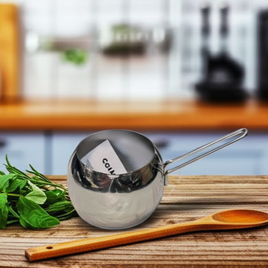 Metal measuring scoop on a wooden cutting board with fresh herbs and a wooden spoon in a kitchen setting