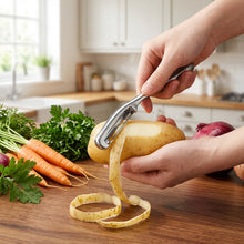 Load image into Gallery viewer, Person using a potato peeler on a potato against a dark background
