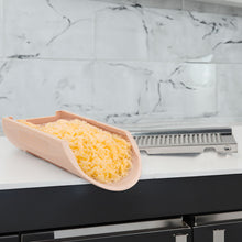 Load image into Gallery viewer, Kitchen grater with grated cheese on a marble countertop
