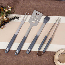 Load image into Gallery viewer, Set of barbecue utensils on a striped placemat with decorative elements.
