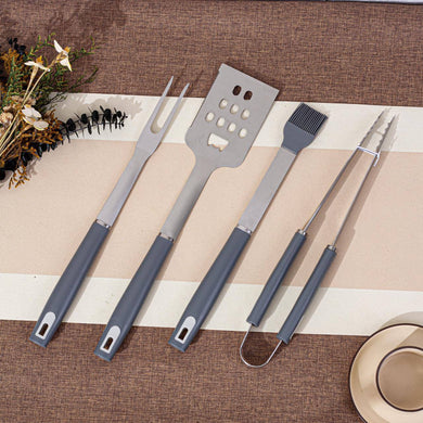Set of barbecue utensils on a striped placemat with decorative elements.