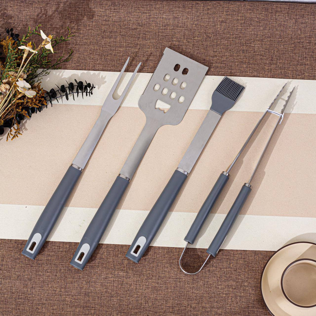 Set of barbecue utensils on a striped placemat with decorative elements.