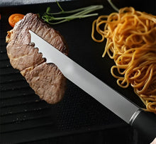 Load image into Gallery viewer, Sliced steak with a knife on a black surface next to noodles and vegetables
