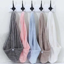 Load image into Gallery viewer, Five pairs of colorful socks hanging on a white wall with black hooks.
