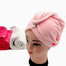 Load image into Gallery viewer, Pink towel turban on a mannequin head with additional towels in the background.
