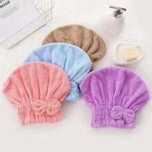 Load image into Gallery viewer, Four colorful hair turbans on a white surface with a blurred background.
