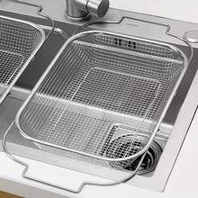 Load image into Gallery viewer, Stainless steel kitchen sink with grid drain and Corian brand name.
