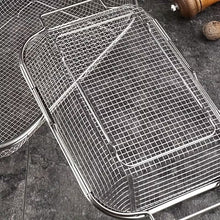 Load image into Gallery viewer, A stainless steel wire mesh basket tray with a raised rim, shown on a dark gray stone surface with another tray partially visible in the background.
