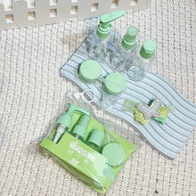 Load image into Gallery viewer, Set of green and clear bottles with caps on a textured surface
