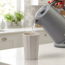 Load image into Gallery viewer, Person pouring water from a kettle into a white mug on a kitchen counter.
