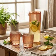 تحميل الصورة في عارض المعرض، Set of ribbed glass carafe and two glasses on a light gray background
