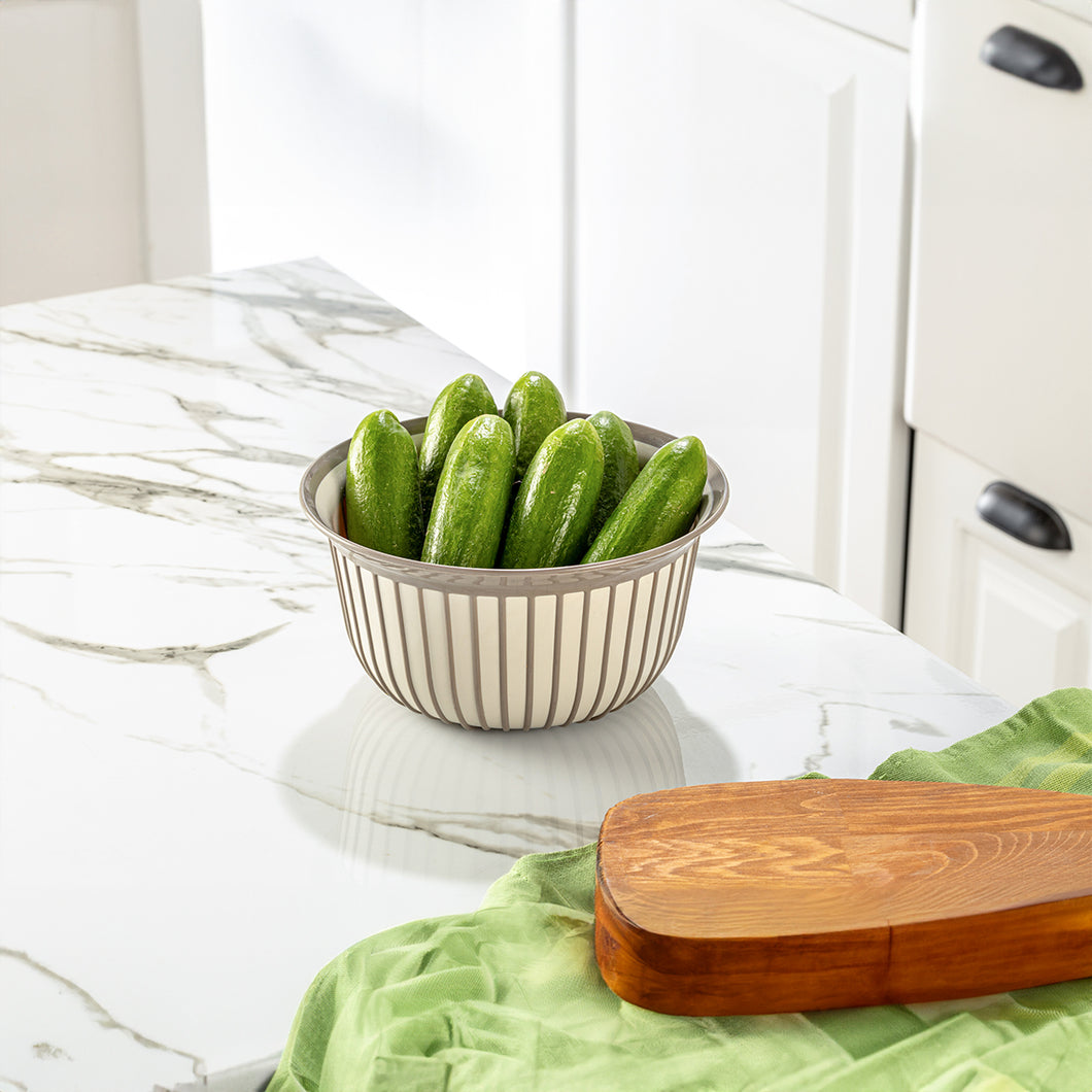 Bowls - Multi Purpose Linea Round Mixing Bowl - ( 2000 ml ) with cucumbers on a marble countertop.