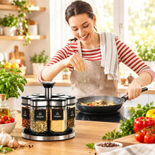 تحميل الصورة في عارض المعرض، Woman cooking in a kitchen with spice containers on the counter.
