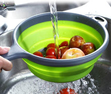 تحميل الصورة في عارض المعرض، Green collapsible colander with fruits being washed under running water in a sink.
