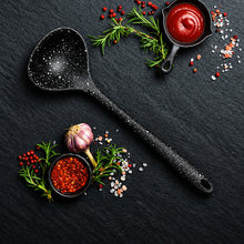 تحميل الصورة في عارض المعرض، Black ladle with spices and herbs on a dark surface
