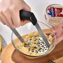 تحميل الصورة في عارض المعرض، Person using a metal grater to add capers into a bowl of food on a wooden board.
