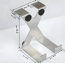 Load image into Gallery viewer, A silver metallic X-shaped phone stand with black circular pads, shown with dimension annotations in Arabic on a light gray background.
