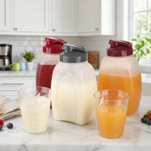 Load image into Gallery viewer, Three plastic condiment bottles with colorful lids on a kitchen counter with glasses of juice.

