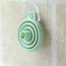 Load image into Gallery viewer, Set of green silicone measuring cups on a beige background
