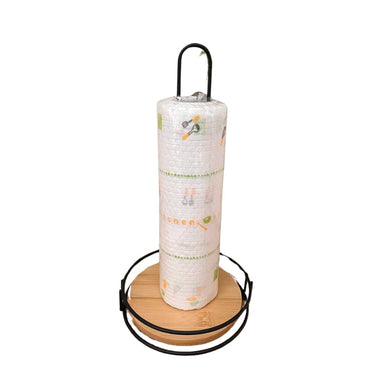 A kitchen tissue holder with a wooden base and a black metal rod, with a roll of paper towels on it.
