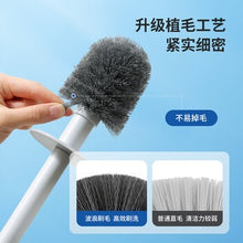 تحميل الصورة في عارض المعرض، Cleaning brush with bristle head held by a hand against a blue background
