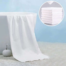 Load image into Gallery viewer, White fitted sheet draped over a bed with a close-up inset of folded white towels.
