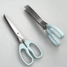 Load image into Gallery viewer, Light blue-handled scissors on a light gray background
