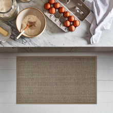 تحميل الصورة في عارض المعرض، Kitchen counter with ingredients and a woven mat in the foreground
