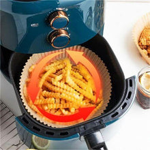 Load image into Gallery viewer, Non-stick disposable air fryer paper liner with crinkle cut fries in an air fryer basket for clean and efficient cooking
