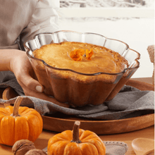 Load image into Gallery viewer, Heat-resistant glass baking bowl with cake topped with flowers, surrounded by pumpkins and cozy kitchen decor.
