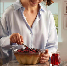 Load image into Gallery viewer, Woman serving dessert from a heat resistant glass bowl, featuring berries and a drink on a table.
