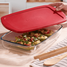 تحميل الصورة في عارض المعرض، Heat-resistant glass tray with red plastic lid, containing baked stuffed peppers, ideal for meal prep and storage.
