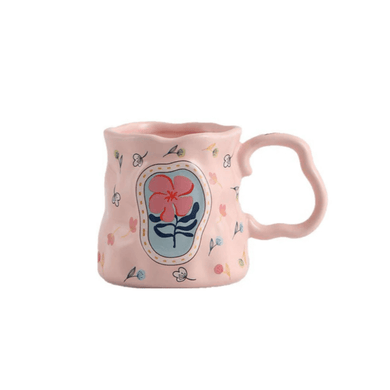 Colorful floral porcelain mug with pink exterior and artistic flower design, ideal for coffee or tea.