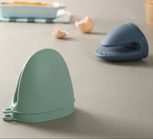 Load image into Gallery viewer, Mini Silicone Oven Mitts Pot Holders - 2 Pcs Premium Silicone Tray Grabber in green and blue on a kitchen counter.
