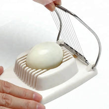 Load image into Gallery viewer, Person using a multifunctional egg slicer to cut a hard-boiled egg into even slices.
