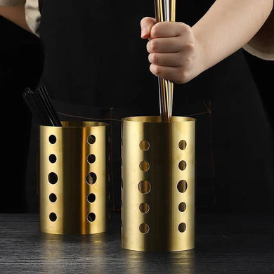 Gold stainless steel cutlery holder and utensil organizer with holes for easy access, neat storage for kitchen utensils.