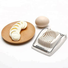 Load image into Gallery viewer, Multifunctional egg slicer with sliced hard-boiled eggs on a plate and a whole egg, ideal for meal prep and garnishing.
