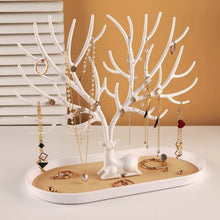 Load image into Gallery viewer, Elegant white deer-shaped jewelry organizer displaying necklaces, earrings, and rings on a chic vanity.
