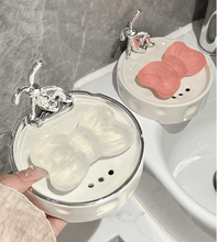 تحميل الصورة في عارض المعرض، Elegant porcelain soap holders with decorative bunny design, showcasing a pink and clear soap on a bathroom sink.

